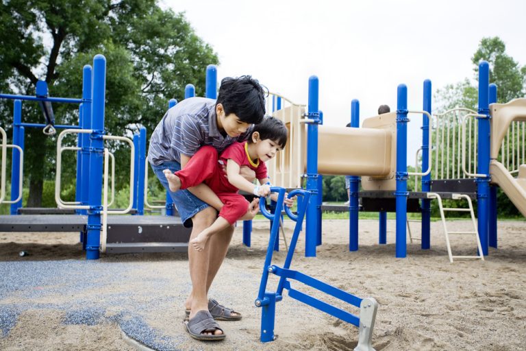 Older,Brother,Helping,Disabled,Sibling,Play,At,Playground