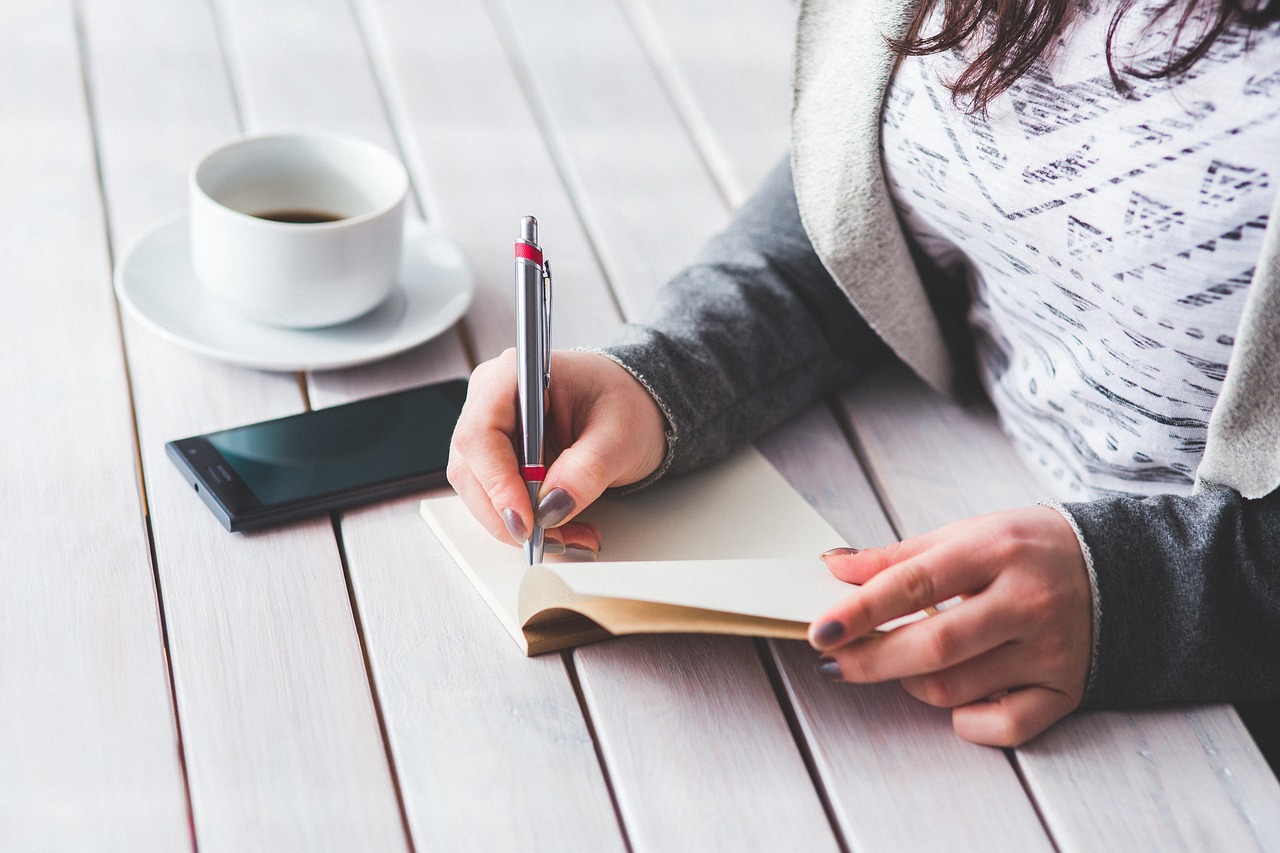 Woman, write, notepad — Futures Trading Discount: Cut Expenses with Limited-Time Prop Firm Discounts